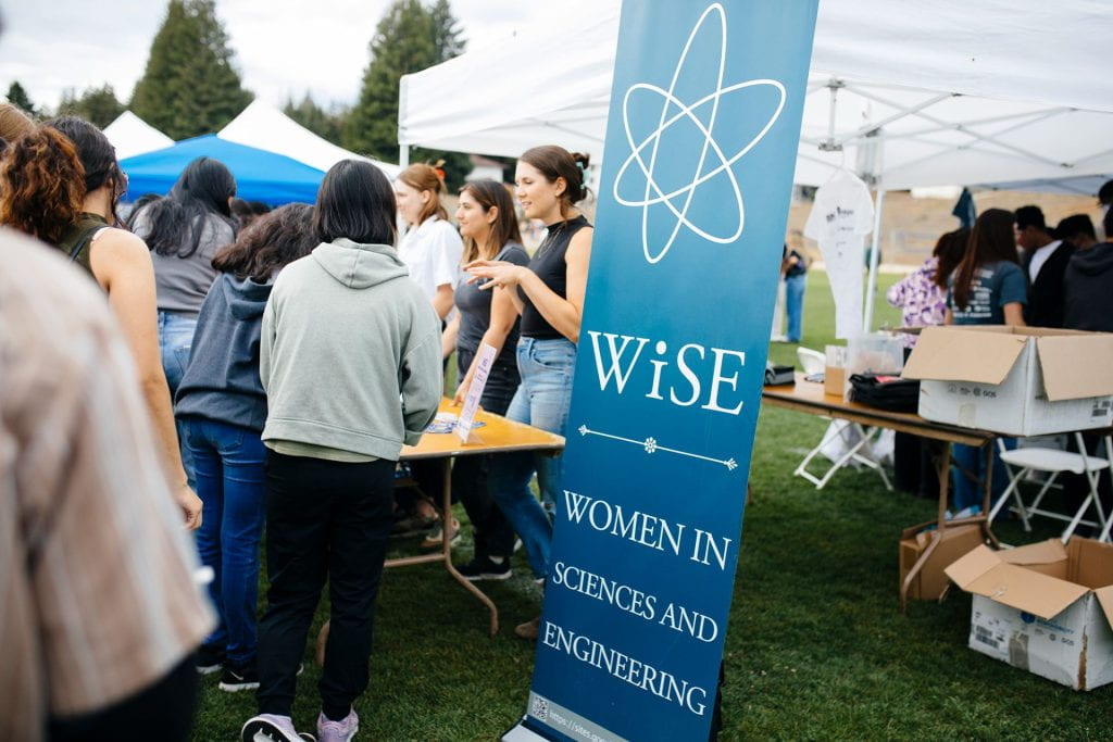 People tabling for WISE which is an organization for Women in Science and Engineering.
